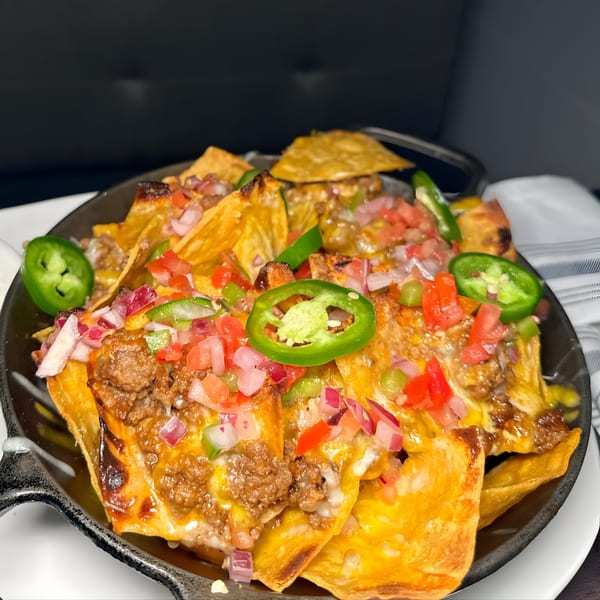 Hilltop Kitchen & Bar's loaded nachos with melted cheese, ground beef, pico de gallo, and jalapeños.