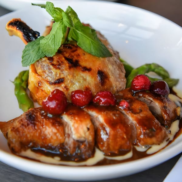 Hilltop Kitchen & Bar's roasted duck with asparagus, cranberries, and a rich sauce.